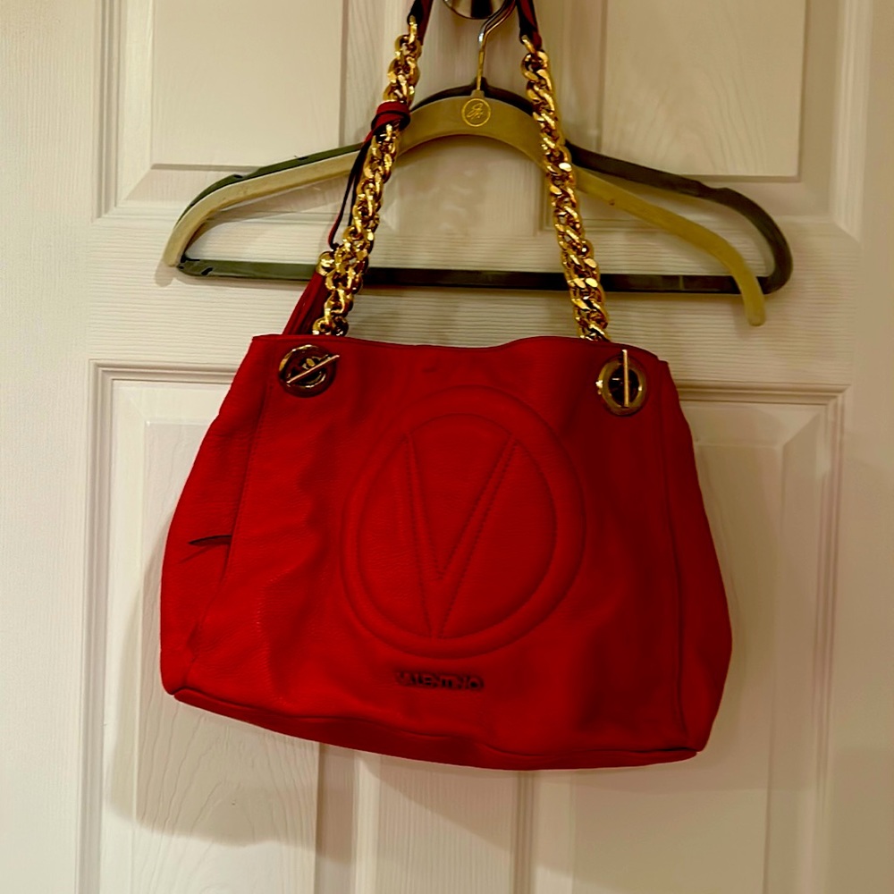 Authentic Valentino Handbag . Red ,lining without stains or rips .